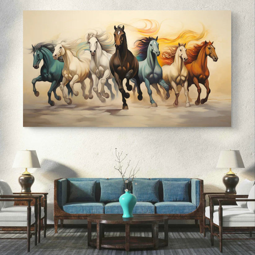 Canvas print of running horses in various colors on a wall above a blue sofa.