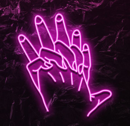 Couple Hand Illustrator Neon Sign – Custom Neon Sign for Living Room Neon pink outline of a hand making a peace sign on a dark background