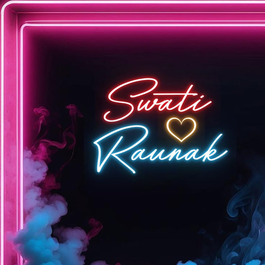 Couples Name Neon Light | Anniversary Gift Neon Light Board Neon sign with 'Swati Rounak' and a heart on a dark background with pink and blue smoke.