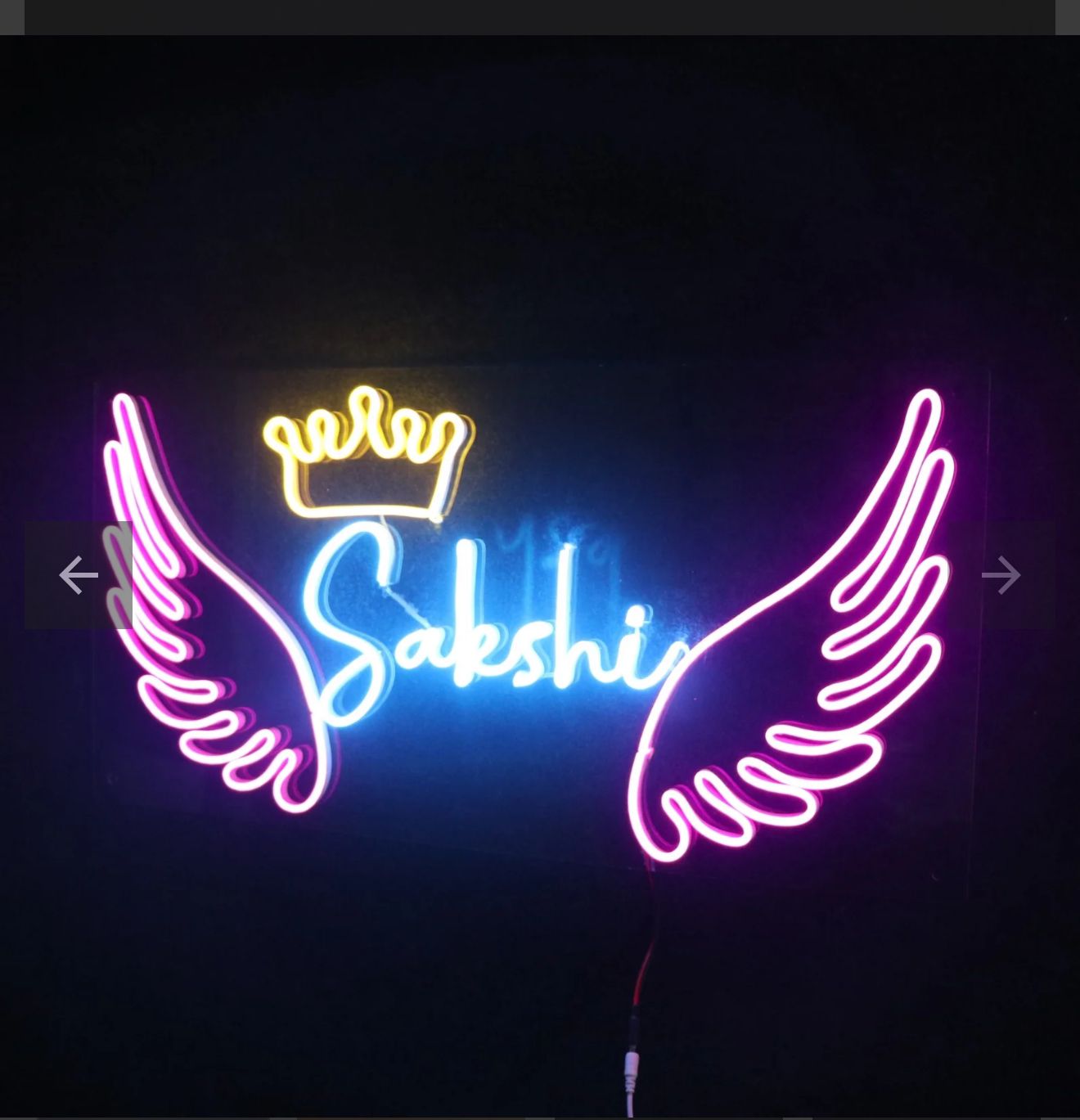 Couples Name Neon Light | Neon Wall Sign for Couple Bedroom Neon sign with wings and a crown above the name 'Sakshi' on a dark background