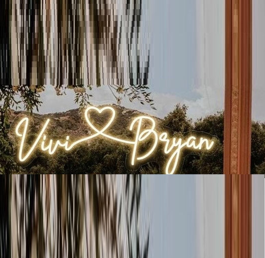 Couples Name Neon Light | Personalized Neon Sign for Lovers Neon sign with 'Vivi Bryan' in a heart shape against a scenic background