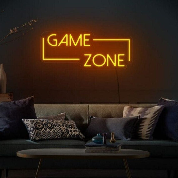 Game Zone Neon Light – Glowing LED Sign for Game Room or Kids Room Neon sign reading 'GAME ZONE' in a dimly lit room with a couch and decorative pillows.