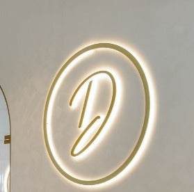 round black acrylic LED halo sign with gold illumination for luxury hospitality and wall decor