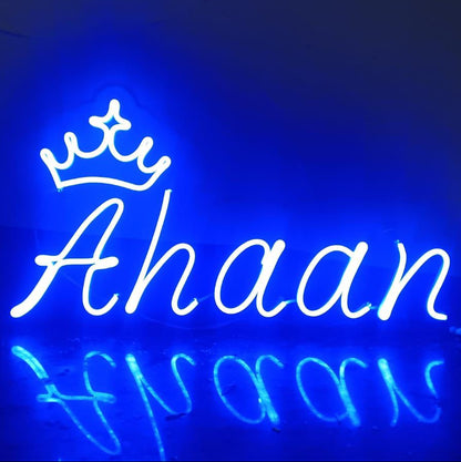Neon sign with 'Ahaan' and a crown design on a dark background