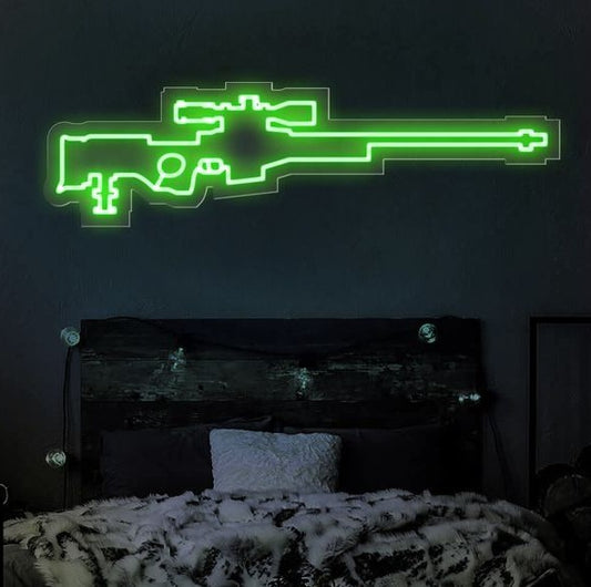 AWM Sniper Neon Sign  – Custom Neon Sign for Living Room 40 By 18 Inches Neon green gun-shaped light fixture on a dark wall above a bed.