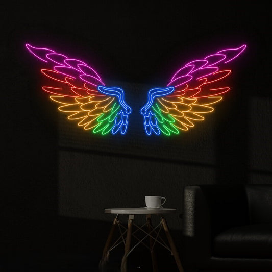 Angel Wings Neon Light for Wall Decors | Big Large Size Angel Wings Neon Light for Selfie Point | Custom Neon Sign (48 by 48 inches) Neon rainbow wings on a dark wall with a cup on a table below.