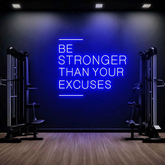 Be Stronger Then Your Neon Sign | Custom Neon Sign | Neon for Gym Wall Decor Neon sign in a gym with motivational quote 'Be Stronger Than Your Excuses' on a dark wall.
