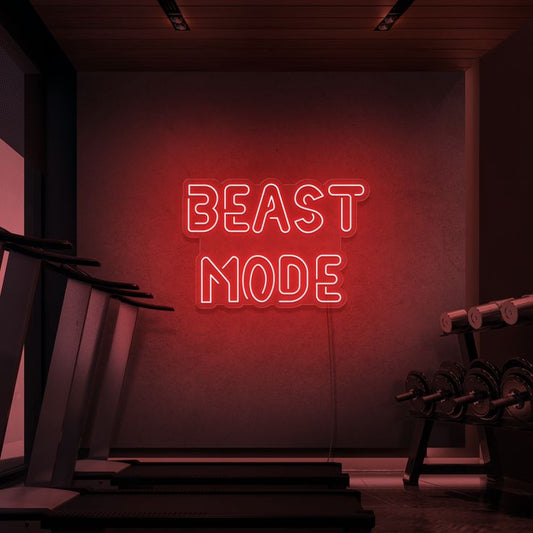 Beast Mode Neon Sign | Custom Neon Sign | Neon for Gym Wall Decor Neon sign reading 'BEAST MODE' in a gym setting with weights and exercise equipment.