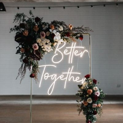 Better Together Neon Sign | Custom Neon Sign | Neon for Living Room Decor Neon sign with 'Better Together' surrounded by floral arrangements on a white background