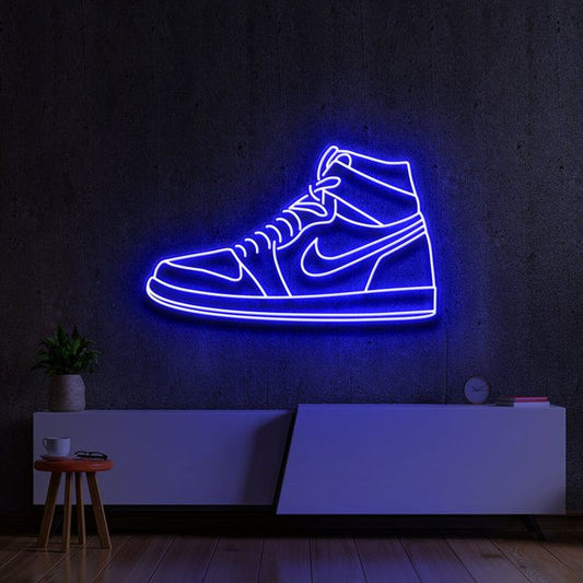 Blue Sneaker Neon Sign | Custom Neon Sign | Neon for Shoe Shop Neon light shaped like a sneaker on a dark wall with minimal decor.