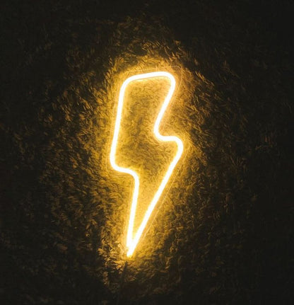 Bolt Electric Neon Sign | Custom Neon Sign | Neon for Living Room Decor Neon lightning bolt shape on a dark textured background