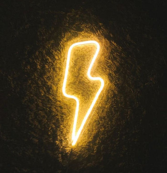 Bolt Electric Neon Sign | Custom Neon Sign | Neon for Living Room Decor Neon lightning bolt shape on a dark textured background