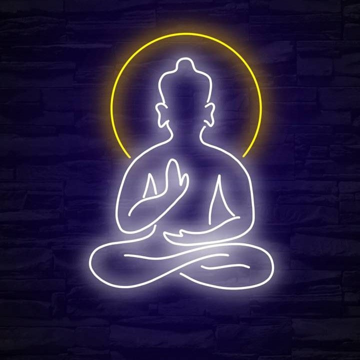 Buddha Meditation Neon Sign | Custom Neon Sign | Neon for Yoda Studio Neon sign of a meditating figure with a yellow halo on a dark brick wall background