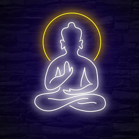 Buddha Meditation Neon Sign | Custom Neon Sign | Neon for Yoda Studio Neon sign of a meditating figure with a yellow halo on a dark brick wall background