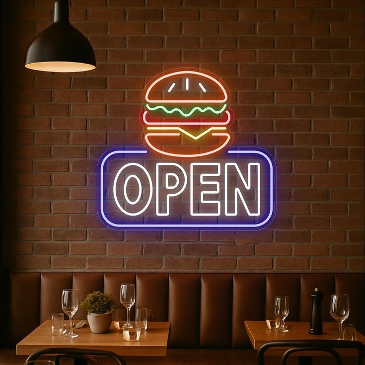 Burger Open Neon Sign | Custom Neon Sign | Neon for Restaurant Neon 'OPEN' sign with burger graphic on a brick wall above restaurant tables.