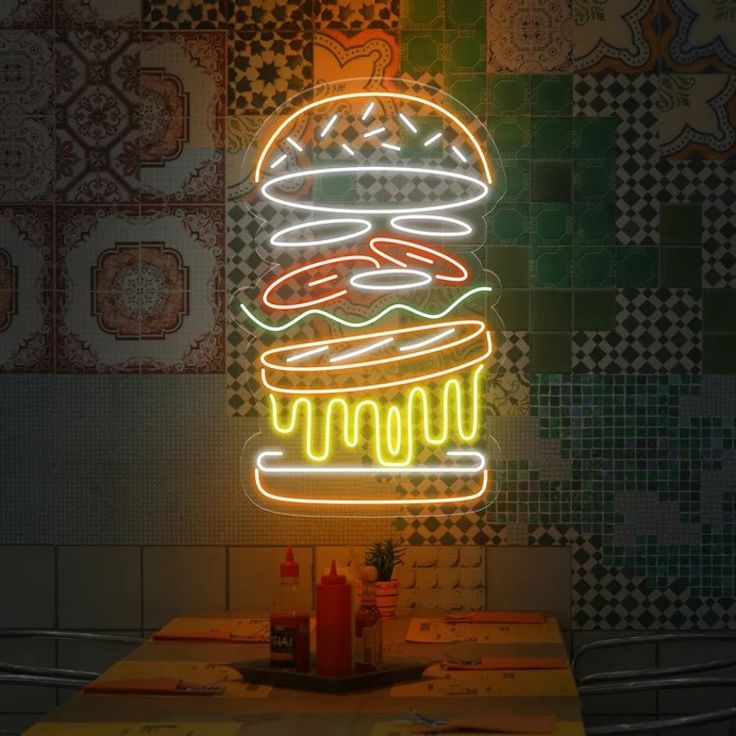 Burger Stuffing Neon Sign | Custom Neon Sign | Neon for Restaurants Sign Neon sign of a hamburger on a tiled wall with condiments on a table below.