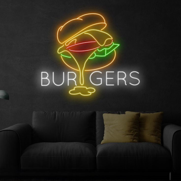 Burgers Meal Neon Sign | Custom Neon Sign | Neon for Restaurant, Cafe Neon sign of a burger with 'BURGERS' text on a dark wall above a sofa.