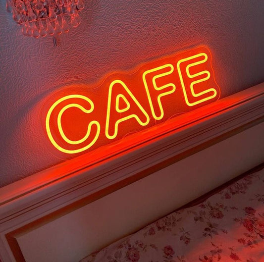 Cafe Neon Sign | Custom Neon Sign | Neon for Restaurant, Cafe Neon 'CAFE' sign on a textured wall with floral wallpaper at the bottom.