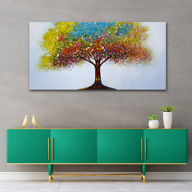 Colorful abstract tree painting on a gray wall above a green cabinet.