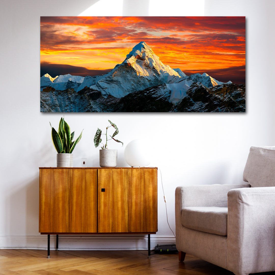 Canvas Painting Wall Frame | Majestic Mount Everest Sunset Landscape | Snow-Capped Himalayan Peak at Golden Hour Big Large Size Painting (48x24 Inches) Living room with a large mountain sunset painting on the wall, wooden cabinet, and gray sofa.