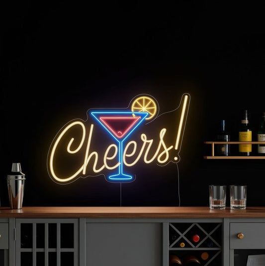 Cheers Glass Neon Sign | Custom Neon Sign | Neon for Bar, Restaurant Neon sign with 'Cheers!' and cocktail graphic on a bar counter.