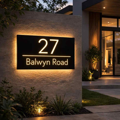 Modern backlit house address plaque featuring glowing house number 27 and Balwyn Road street name on a contemporary home entrance.