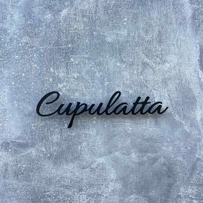 Modern 3D-style black cursive name signage mounted on a beige wall and wooden slat feature wall in a contemporary interior.