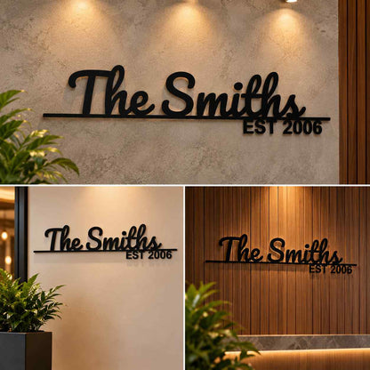 Modern personalized surname wall decor with dimensional black cursive lettering and established year, displayed on wooden slat and plaster feature walls.