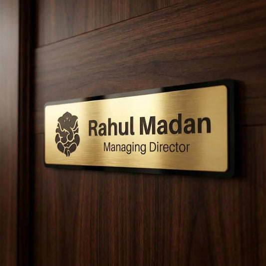 Premium brushed gold corporate name sign with black border and personalised executive designation mounted on a wooden office door.