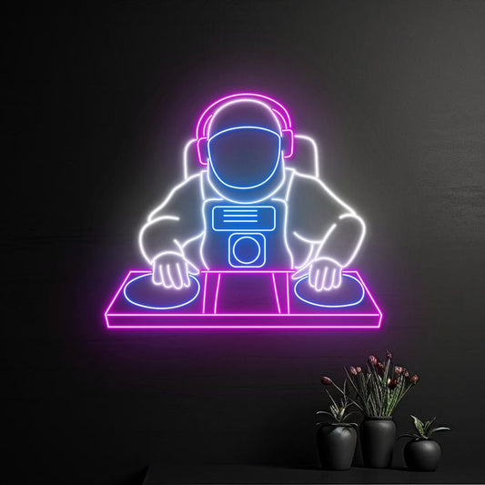 DJ Play Boy Neon Sign – Custom Neon Sign for Living Room Neon sign of an astronaut DJing with plants on a dark background