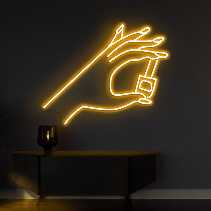 Finder Nail Art Neon Sign | Custom Neon Sign | Neon for Makeup Studio Neon light sculpture of a hand holding a light bulb on a dark wall.