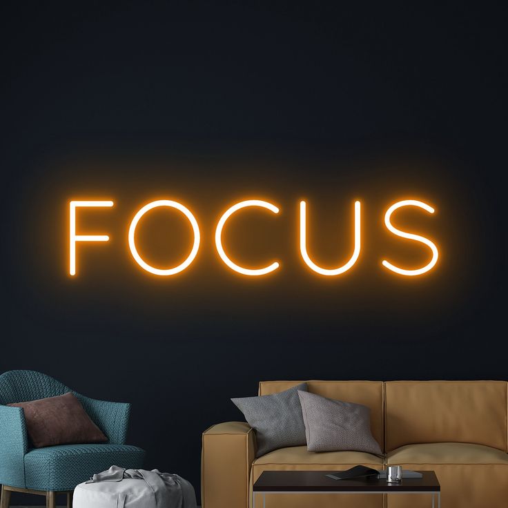 Focus Neon Sign | Custom Neon Sign | Neon for Office, Living Space Neon sign with the word 'FOCUS' in a living room setting.