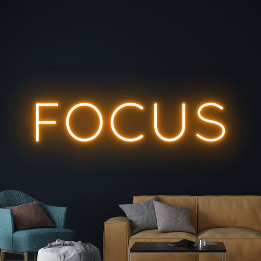 Focus Neon Sign | Custom Neon Sign | Neon for Office, Living Space Neon sign with the word 'FOCUS' in a living room setting.