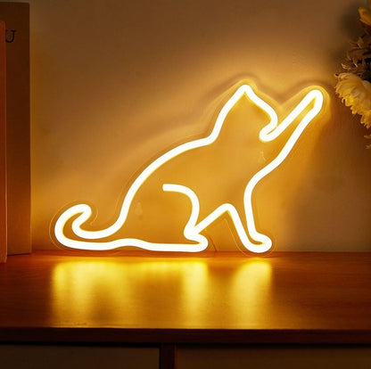 Funny Cat Neon Sign | Custom Neon Sign | Neon for Living Room Decor Neon light shaped like a cat on a wooden surface with a warm glow.