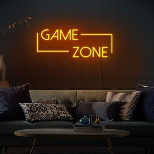 Game Zone Neon Light – Glowing LED Sign for Game Room or Kids Room Neon sign reading 'GAME ZONE' in a dimly lit room with a couch and decorative pillows.