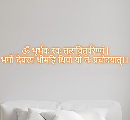 Gayatri Mantra Neon Light Led Wall Decor | Gaytri Mantra in Neon Lights | Gayatri Mantra Wall Decor | Custom Neon Light Hindi text on a light gray wall with a white sofa below