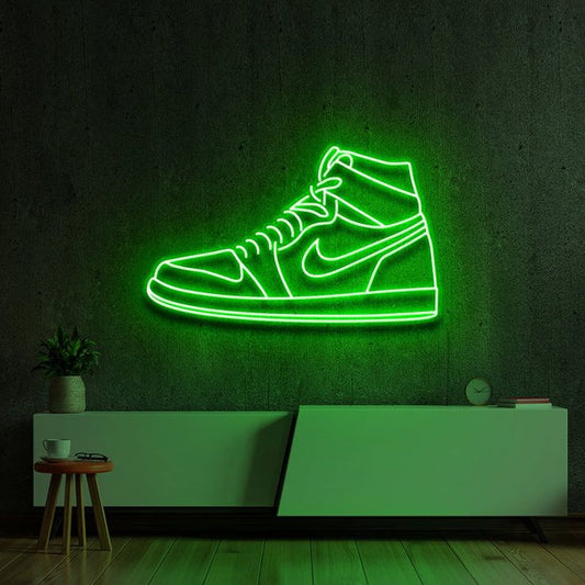 Green Sneaker Neon Sign | Custom Neon Sign | Neon for Shoe Shop Neon green shoe-shaped light fixture on a dark wall with minimal decor.