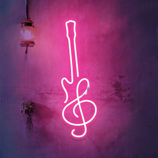 Guitar Neon Sign | Custom Neon Sign | Neon for Music Studio Neon guitar and treble clef sign on a textured wall with a hanging lamp.