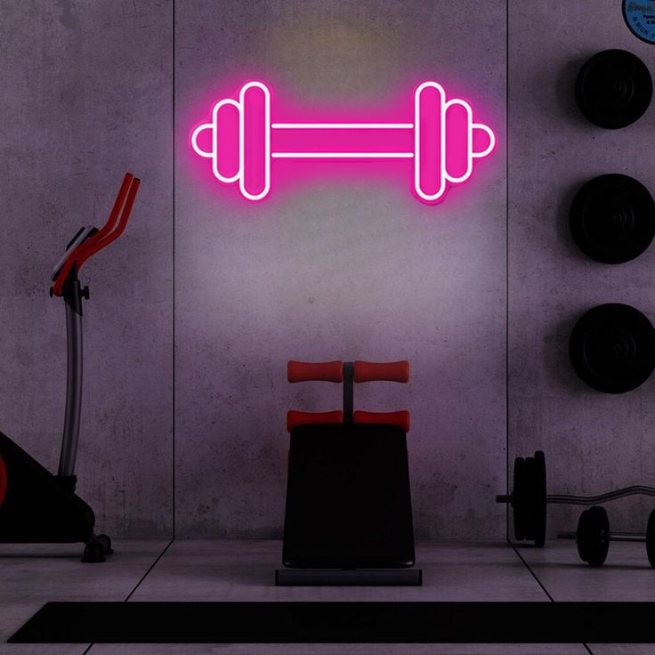 Gym Dumble Neon Sign | Custom Neon Sign | Neon for Living Room Neon pink dumbbell sign in a gym setting with exercise equipment.