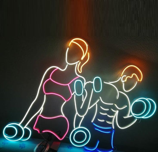 Gym and Fitness Neon Sign | Custom Neon Sign | Neon for Gym Wall Decor Neon outlines of a woman and a man lifting weights on a dark background