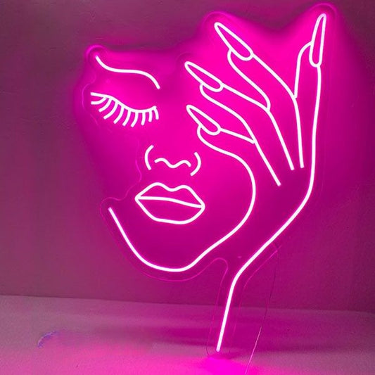 Half Face Girl Neon Sign | Custom Neon Sign | Neon for Makeup Studio Neon sign of a face and hand on a pink background