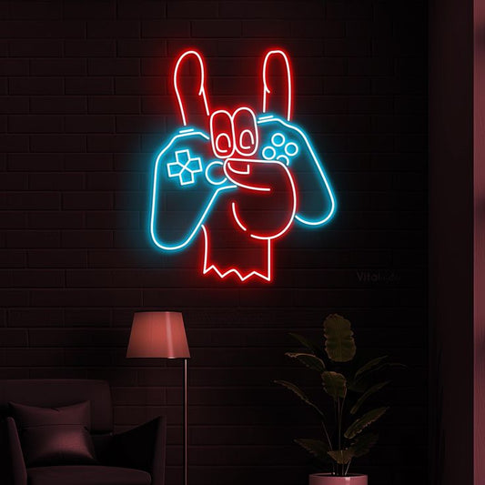 Hand Game Remote Neon Sign – Custom Neon Sign for Living Room 18 By 18 Inches Neon sign of a character holding gaming controllers on a dark brick wall.