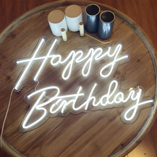 Happy Birthday Neon Sign | Custom Neon Sign | Neon for Birthday Decor Neon 'Happy Birthday' sign on a wooden surface with coffee cups in the background