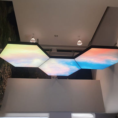 Custom hexagon fabric light box ceiling with illuminated printed graphics in a modern interior