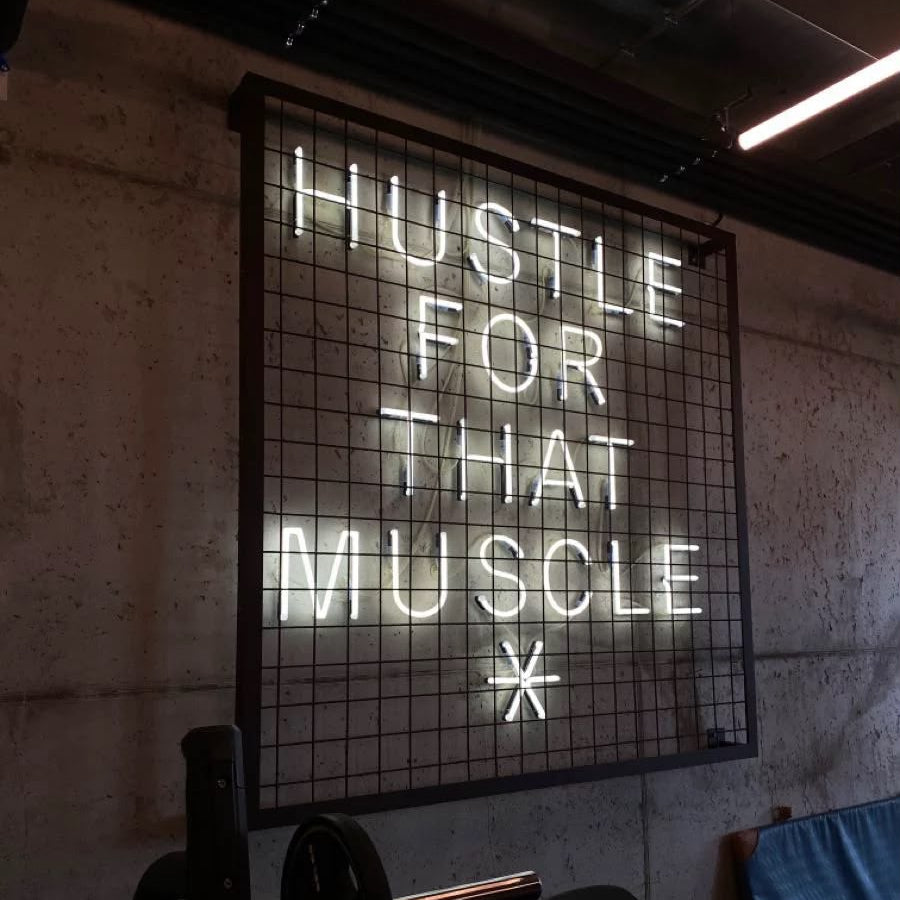 Motivational gym LED neon wall sign with Hustle For That Muscle quote for home gym and fitness club