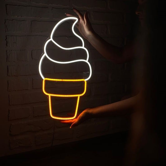 Ice Cream Cone Neon Sign | Custom Neon Sign | Neon for Restaurant, Cafe Neon light shaped like an ice cream cone against a dark brick wall.