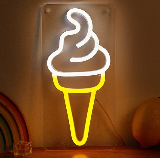 Ice Cream Neon Sign | Custom Neon Sign | Neon for Restaurant, Cafe Neon sign of an ice cream cone on a reflective surface with a rainbow and fruit in the background.