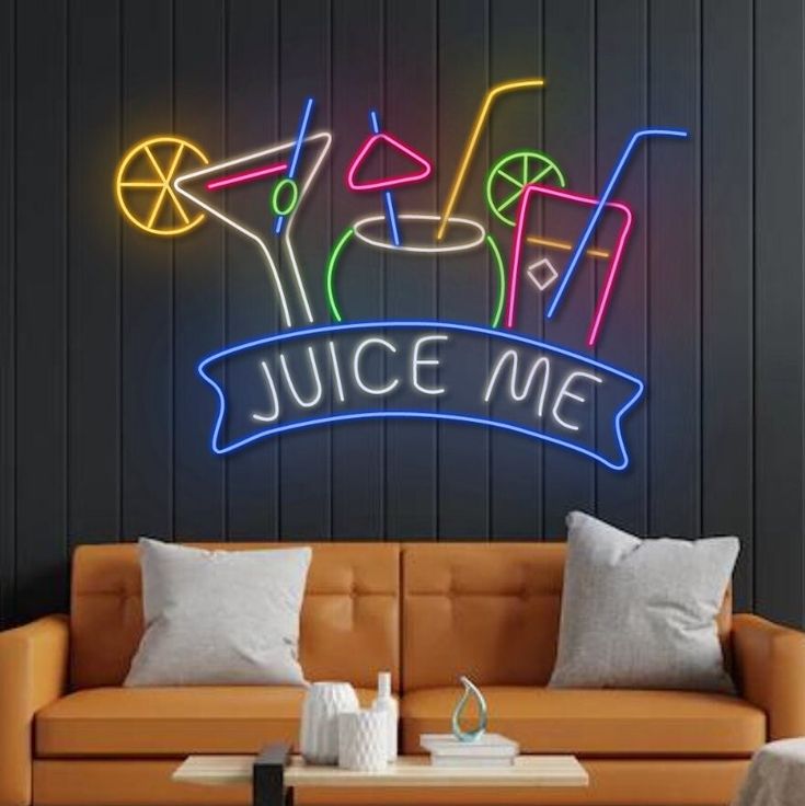 Juice Me Glass Neon Sign | Custom Neon Sign | Neon for Restaurant, Cafe Neon sign with cocktail graphics and 'Juice Me' text above an orange couch.