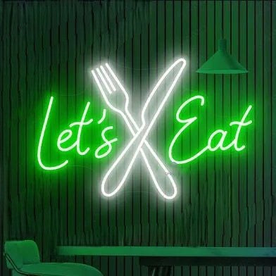 Knife & Spoon Neon Sign | Lets Eat Custom Neon Sign | Neon for Restaurants Neon sign with crossed fork and knife and 'Let's Eat' text on a green background