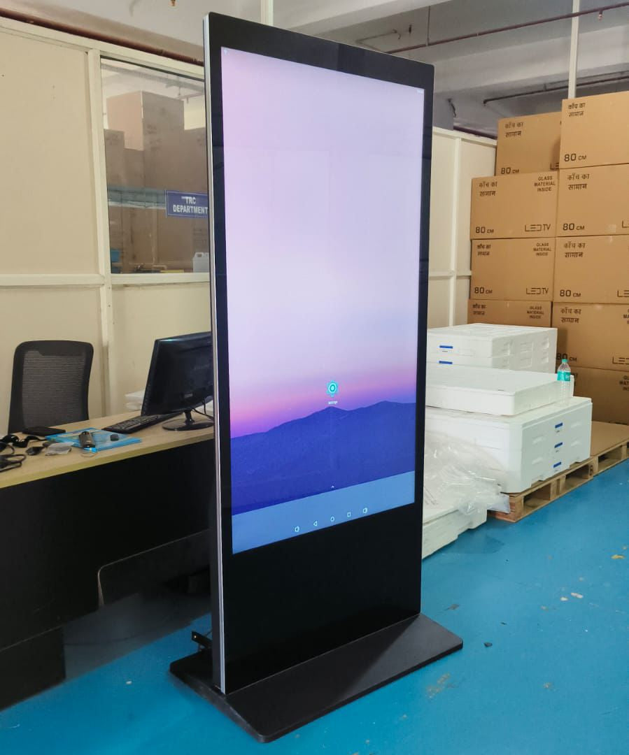  LED Digital Standee Video Display Signage Touch Screen for Branding, Advertising | Digital Advertising Display Screen | Led Video Standee 32" I Type - Touch Screen Tall vertical screen displaying a mountain landscape in an indoor setting with office furniture and boxes in the background.